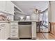 Eat-in kitchen featuring stainless steel dishwasher and wood floors at 5228 Boone Ct, Villa Rica, GA 30180