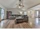 Open floor plan living room with vaulted ceilings, fan, wood flooring, and gray sectional at 5228 Boone Ct, Villa Rica, GA 30180