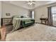 Large primary bedroom with tray ceiling, bedside tables, and plush carpeting at 5228 Boone Ct, Villa Rica, GA 30180