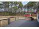 A wood deck with a view of the fenced-in backyard, the shed and trees at 62 W Lakeview Dr, Temple, GA 30179