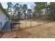 Fenced backyard with trees, grass, a patio, and access to the house at 62 W Lakeview Dr, Temple, GA 30179