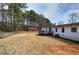 Overview of a backyard featuring a wood deck, fenced yard, shed, trees, and the house exterior at 62 W Lakeview Dr, Temple, GA 30179