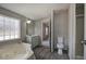 Bathroom featuring a tub, vanity, toilet, walk-in shower, and wood-look flooring at 62 W Lakeview Dr, Temple, GA 30179