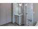 Bright bathroom featuring a vanity with marble countertop and a mirror with gray walls and wood-look flooring at 62 W Lakeview Dr, Temple, GA 30179