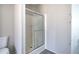 Bathroom featuring a glass enclosed shower with light colored walls and wood-look flooring at 62 W Lakeview Dr, Temple, GA 30179