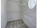 Walk-in closet with shelves and carpeting with a view to the outside through a geometric window at 62 W Lakeview Dr, Temple, GA 30179