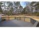 A dark wood deck with backyard view, offering a relaxed outdoor space at 62 W Lakeview Dr, Temple, GA 30179