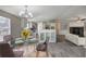 Open-concept dining area with a glass table and modern chandelier, blending seamlessly with the kitchen at 62 W Lakeview Dr, Temple, GA 30179