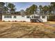 Charming single-story home with a well-maintained lawn and classic architectural details at 62 W Lakeview Dr, Temple, GA 30179