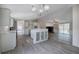 A view of the kitchen and living room with an island, stainless steel appliances, and a fireplace at 62 W Lakeview Dr, Temple, GA 30179
