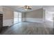 Living room with stone fireplace, ceiling fan, and sliding doors to the back deck at 62 W Lakeview Dr, Temple, GA 30179