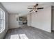 A view of the living room into the kitchen with a ceiling fan and lots of natural light at 62 W Lakeview Dr, Temple, GA 30179