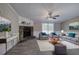 Inviting living room featuring a stone fireplace, comfortable seating, and plenty of natural light at 62 W Lakeview Dr, Temple, GA 30179