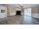 Living room with stone fireplace and ceiling fan with sliding doors to back deck visible at 62 W Lakeview Dr, Temple, GA 30179