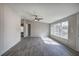 Sun-filled living room offers wood-look floors and a modern ceiling fan at 62 W Lakeview Dr, Temple, GA 30179