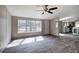 Bright living room featuring wood-look floors, ceiling fan and natural light at 62 W Lakeview Dr, Temple, GA 30179
