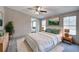 Comfortable main bedroom featuring soft bedding, ambient lighting, and view to connected bedroom or sitting area at 62 W Lakeview Dr, Temple, GA 30179