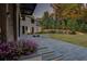 Elegant backyard and patio featuring a stone tile area with landscaped flower beds at 700 N Island Dr, Atlanta, GA 30327