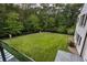 Well-maintained lawn in a spacious backyard, surrounded by lush trees and privacy fencing at 700 N Island Dr, Atlanta, GA 30327