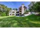 A modern home backyard with a lush lawn, ample space, and steps to a covered porch at 700 N Island Dr, Atlanta, GA 30327