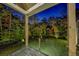 Inviting covered patio with glass railing overlooking private backyard at 700 N Island Dr, Atlanta, GA 30327
