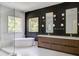 A modern bathroom features a freestanding tub, dual vanities, and a window view at 700 N Island Dr, Atlanta, GA 30327