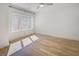 Bedroom with ceiling fan, hardwood floors, white walls, large windows, and black curtain rod at 700 N Island Dr, Atlanta, GA 30327