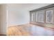 Bright bedroom features hardwood floors, white trim and paint, and three large windows at 700 N Island Dr, Atlanta, GA 30327