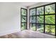 Sunlight streams through these large windows in this room with hardwood flooring and a view of greenery at 700 N Island Dr, Atlanta, GA 30327