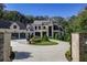 A beautiful two-story home with an inviting circular driveway and elegant landscaping at 700 N Island Dr, Atlanta, GA 30327