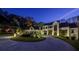 An elegant home illuminated at twilight, showcasing a beautiful circular driveway at 700 N Island Dr, Atlanta, GA 30327