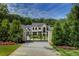 Stately gated home with a manicured lawn and beautiful landscaping at 700 N Island Dr, Atlanta, GA 30327