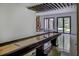 Large recreation room with a shuffleboard table, high ceilings with wood accents, and sliding glass doors at 700 N Island Dr, Atlanta, GA 30327
