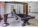 Game room with a modern pool table, high-top table, unique lighting, and industrial-chic design elements at 700 N Island Dr, Atlanta, GA 30327