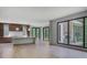 The open concept kitchen features an island, dark cabinetry, marble countertops, and sliding glass doors to the outside at 700 N Island Dr, Atlanta, GA 30327