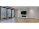 Bright living room with a marble fireplace, hardwood floors, and picture windows overlooking trees at 700 N Island Dr, Atlanta, GA 30327