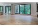 Open living space with hardwood floors, large windows, and access to outdoor living space at 700 N Island Dr, Atlanta, GA 30327