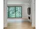 Modern living room featuring a large window, fireplace, and hardwood floors at 700 N Island Dr, Atlanta, GA 30327