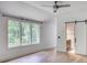 Bright bedroom with a barn door entrance to the bathroom and a large window overlooking mature trees at 700 N Island Dr, Atlanta, GA 30327