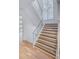 Elegant staircase featuring wood treads, glass railings, and a large window at 700 N Island Dr, Atlanta, GA 30327