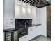 Stylish wet bar with stainless steel appliances, modern cabinets, and marble backsplash at 700 N Island Dr, Atlanta, GA 30327