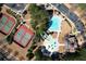 Aerial view of tennis courts, community pool, splashpad, and clubhouse offering recreational amenities at 339 Southgate Dr, Locust Grove, GA 30248