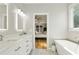 Bright bathroom with a soaking tub, quartz countertops, and modern fixtures at 339 Southgate Dr, Locust Grove, GA 30248