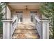 Charming back porch with stone steps and balustrade, offering access to the landscaped backyard and mature trees at 3871 Trickum Road Ne, Marietta, GA 30066