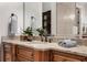 Well-lit bathroom vanity featuring a granite countertop, wood cabinets, and decorative accents at 3871 Trickum Road Ne, Marietta, GA 30066