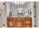 Bathroom vanity featuring a large mirror, wood cabinets, and elegant lighting at 3871 Trickum Road Ne, Marietta, GA 30066