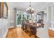 Elegant dining room with large windows, hardwood floors, a decorative chandelier, and classic wainscoting at 3871 Trickum Road Ne, Marietta, GA 30066