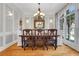 Formal dining room featuring hardwood floors, elegant chandelier, and ample natural light, perfect for entertaining guests at 3871 Trickum Road Ne, Marietta, GA 30066