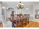 Bright dining room featuring a dark wood table, light gray walls, and access to the kitchen, offering a warm space at 3871 Trickum Road Ne, Marietta, GA 30066