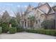 Elegant stone and brick home featuring beautiful architectural details, mature landscaping, and a spacious driveway at 3871 Trickum Road Ne, Marietta, GA 30066